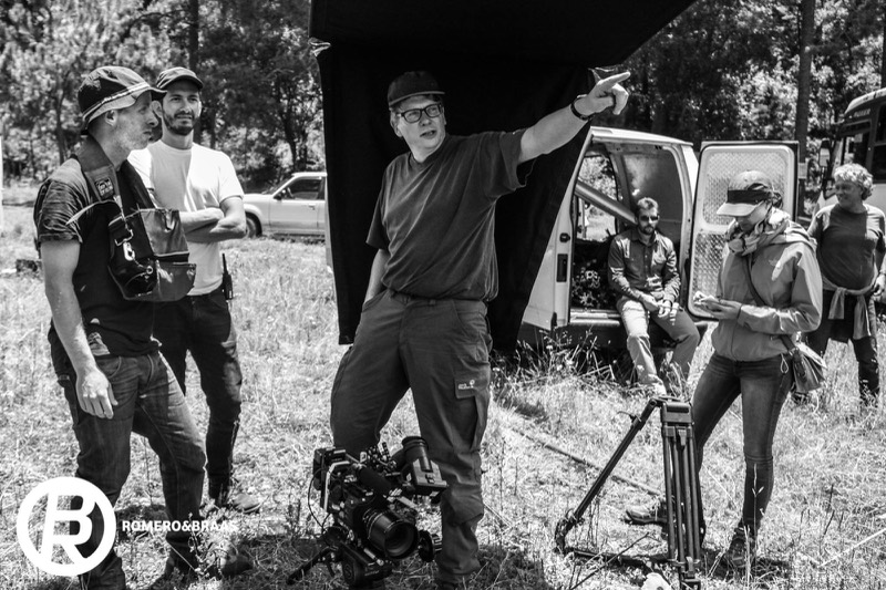 Director blocking a scene with crew on location outdoors