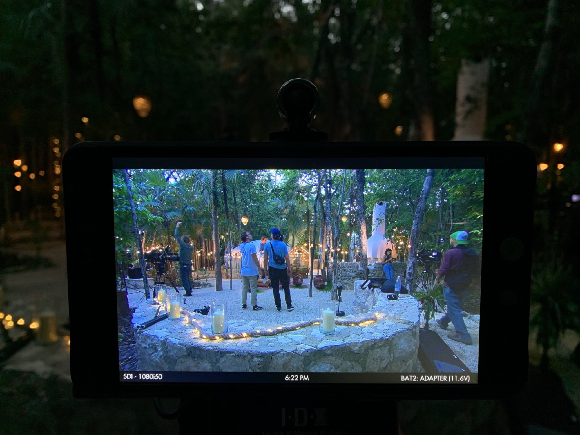Video village monitor showing a candlelit night set in the jungle