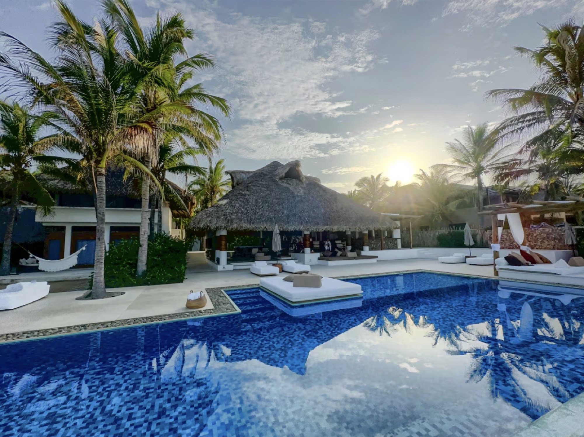 Oceanfront villa pool terrace at golden hour on the Oaxaca Pacific coast
